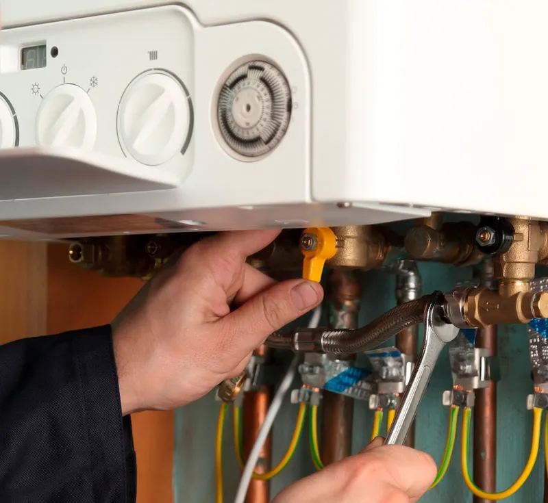 Technician repairing boiler